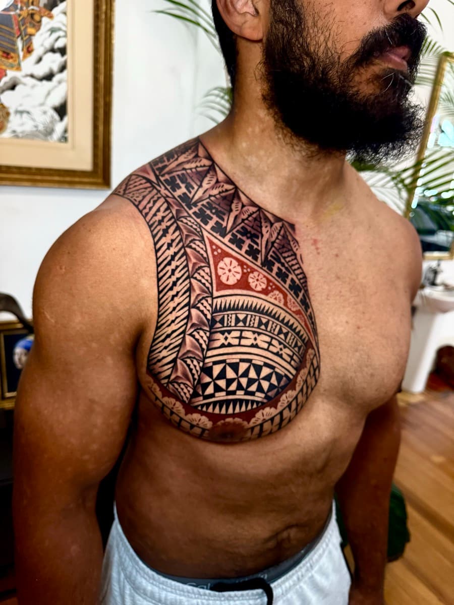 Artist checking tattoo stencil placement on a client's forearm