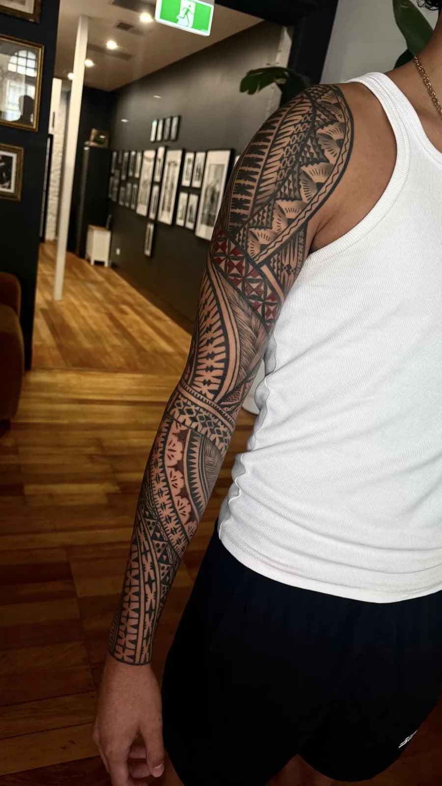 Full Polynesian sleeve by Ameo Bolaira, banded blackwork patterns flowing from shoulder to wrist